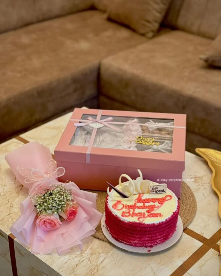 Birthday gift set with red velvet cake, pink rose bouquet, and large pink surprise gift box.