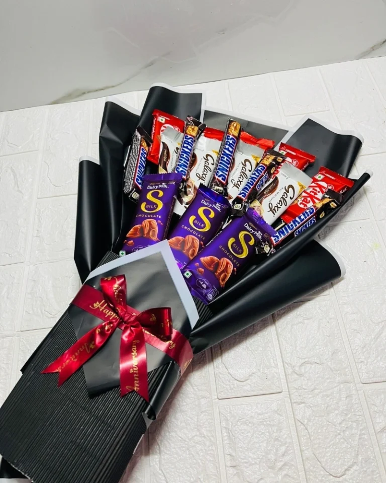 Large chocolate bouquet with Dairy Milk Silk, Snickers, and KitKat, wrapped in black paper.